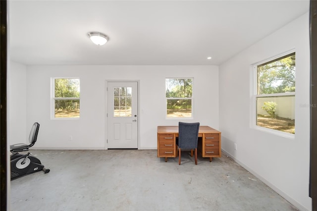6549 NW 65th Pl, Ocala, FL 34482 - office area featuring baseboards, concrete floors, and a healthy amount of sunlight