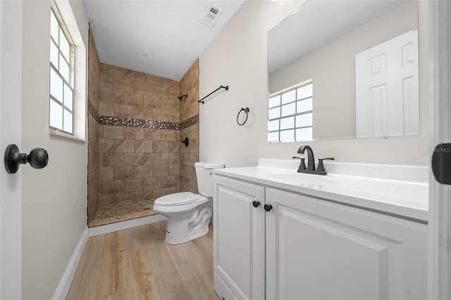 341 SE 53rd Ct, Ocala, FL 34480 - bathroom with toilet, wood finished floors, a tile shower, and visible vents
