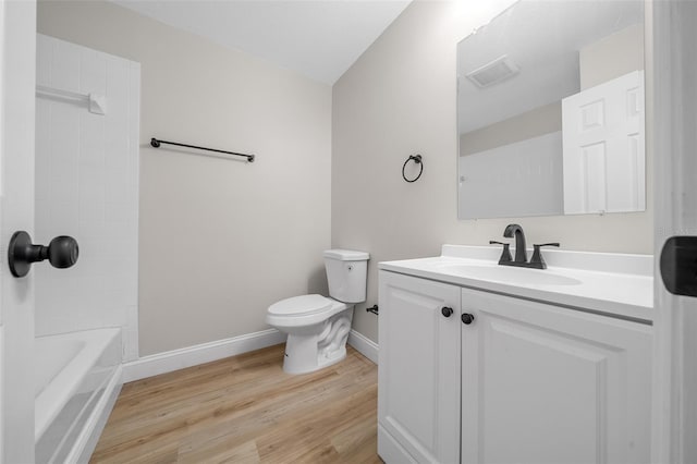 341 SE 53rd Ct, Ocala, FL 34480 - full bathroom with visible vents, baseboards, wood finished floors, toilet, and vanity
