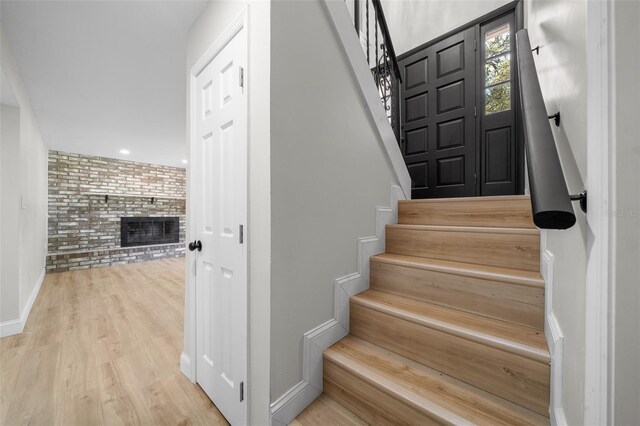 341 SE 53rd Ct, Ocala, FL 34480 - staircase featuring baseboards, a fireplace, and wood finished floors