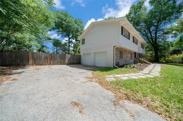 341 SE 53rd Ct, Ocala, FL 34480 - view of side of home with driveway, brick siding, a garage, and fence