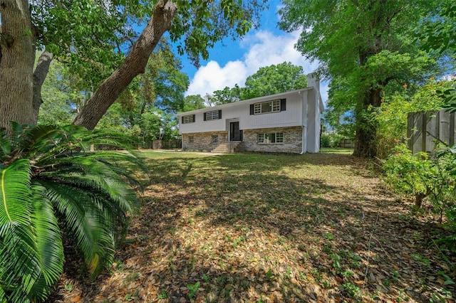 341 SE 53rd Ct, Ocala, FL 34480 - view of front of home featuring fence, entry steps, a front lawn, brick siding, and a chimney