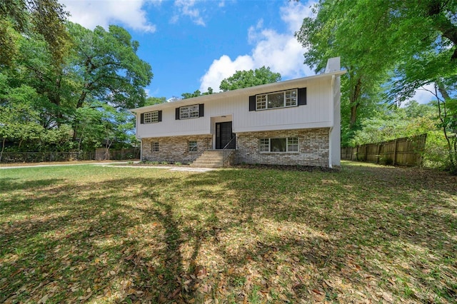 341 SE 53rd Ct, Ocala, FL 34480 - split foyer home with brick siding, a front yard, fence, and entry steps