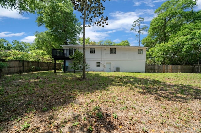 341 SE 53rd Ct, Ocala, FL 34480 - rear view of house featuring central AC, a fenced backyard, a lawn, and a deck