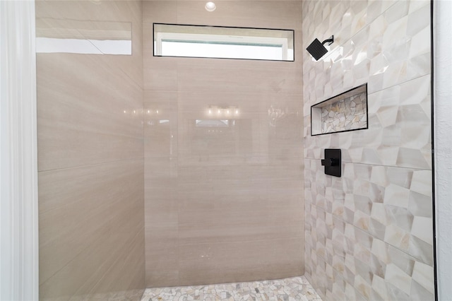 bathroom with tiled shower