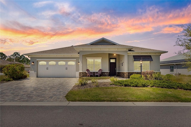 9342 SW 102nd Terrace Rd, Ocala, FL 34481 - view of front of property with driveway, covered porch, stone siding, stucco siding, and a garage