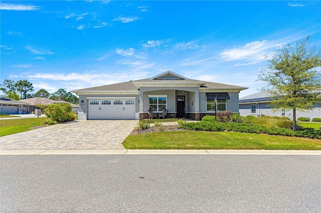 9342 SW 102nd Terrace Rd, Ocala, FL 34481 - view of front facade featuring stone siding, driveway, an attached garage, a front yard, and stucco siding