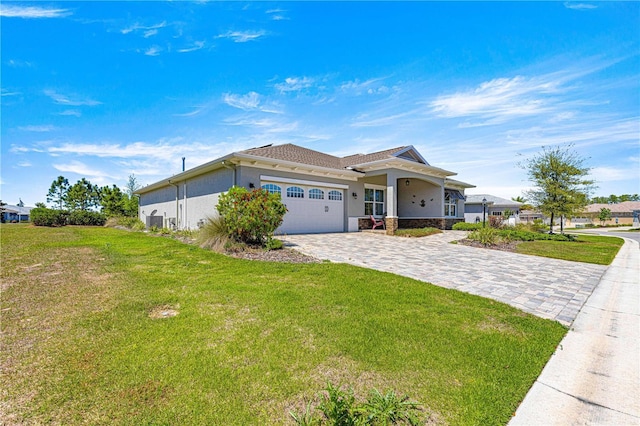 9342 SW 102nd Terrace Rd, Ocala, FL 34481 - view of front of property featuring a front yard, decorative driveway, a garage, and stucco siding