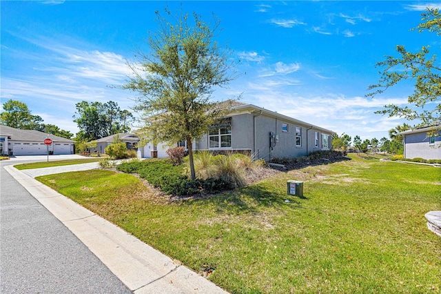 9342 SW 102nd Terrace Rd, Ocala, FL 34481 - view of front of home featuring a front yard, stucco siding, and concrete driveway
