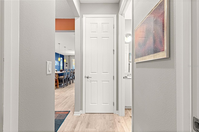 9342 SW 102nd Terrace Rd, Ocala, FL 34481 - hall featuring wood finished floors and a textured wall