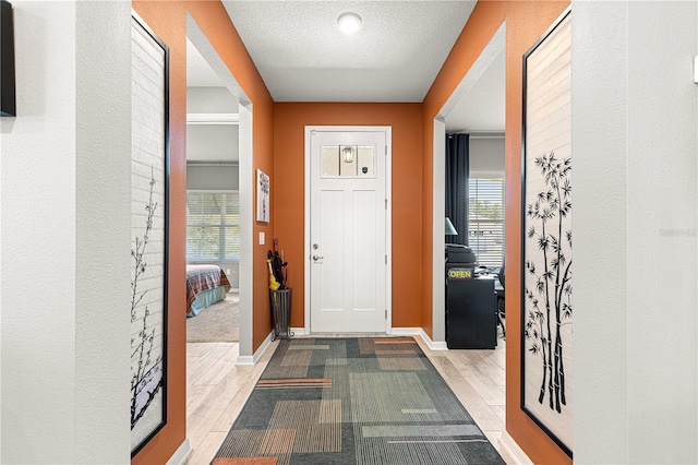 9342 SW 102nd Terrace Rd, Ocala, FL 34481 - foyer entrance with baseboards, a healthy amount of sunlight, and wood finished floors