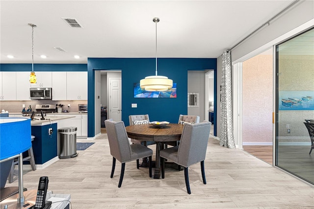 9342 SW 102nd Terrace Rd, Ocala, FL 34481 - dining space with baseboards, visible vents, recessed lighting, and light wood-type flooring