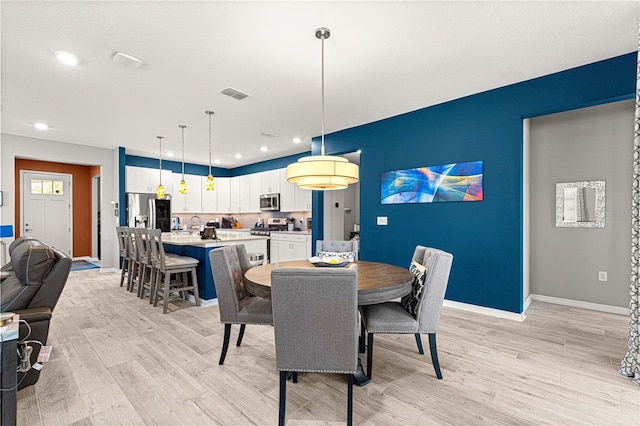 9342 SW 102nd Terrace Rd, Ocala, FL 34481 - dining room featuring baseboards, visible vents, recessed lighting, and light wood-type flooring