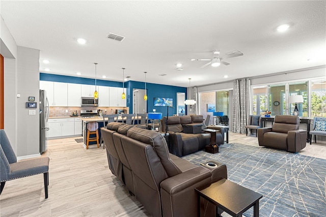 9342 SW 102nd Terrace Rd, Ocala, FL 34481 - living room featuring a ceiling fan, light wood-style flooring, recessed lighting, and visible vents
