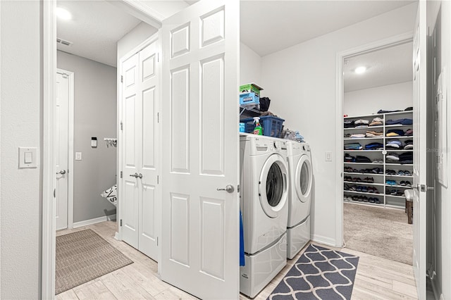 9342 SW 102nd Terrace Rd, Ocala, FL 34481 - washroom with light wood-style flooring, laundry area, baseboards, visible vents, and washer and dryer