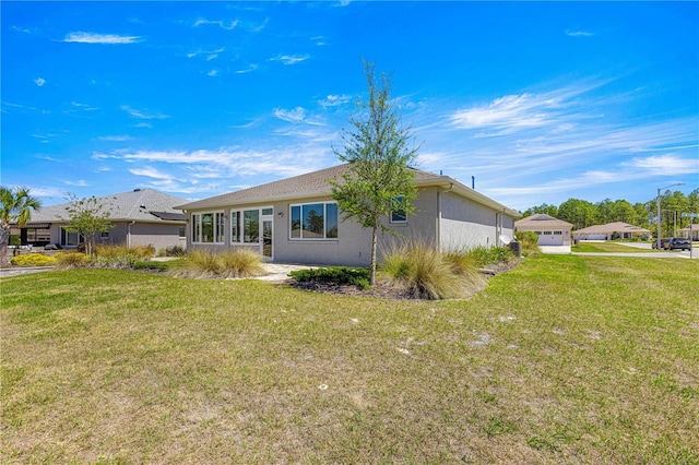 9342 SW 102nd Terrace Rd, Ocala, FL 34481 - back of property with stucco siding and a lawn