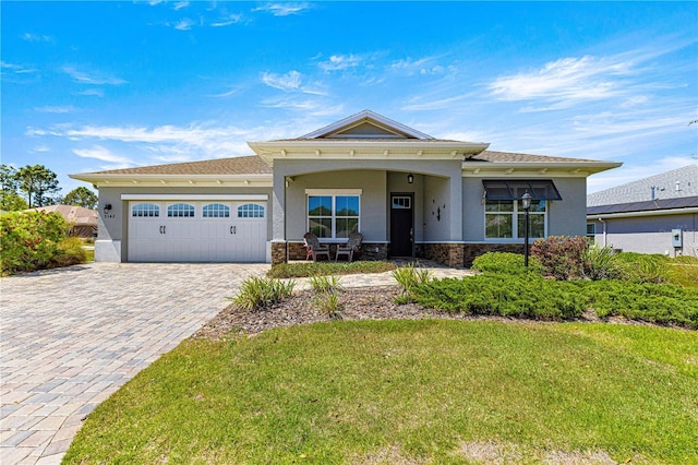 9342 SW 102nd Terrace Rd, Ocala, FL 34481 - view of front facade with decorative driveway, stucco siding, an attached garage, and stone siding