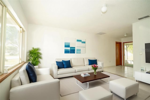 living area with visible vents and tile patterned flooring
