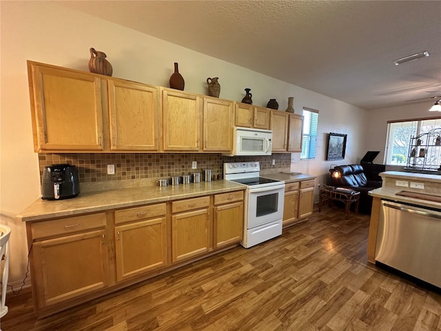 9053 SW 103rd Ave, Ocala, FL 34481 - kitchen featuring white appliances, wood finished floors, backsplash, light countertops, and light brown cabinetry