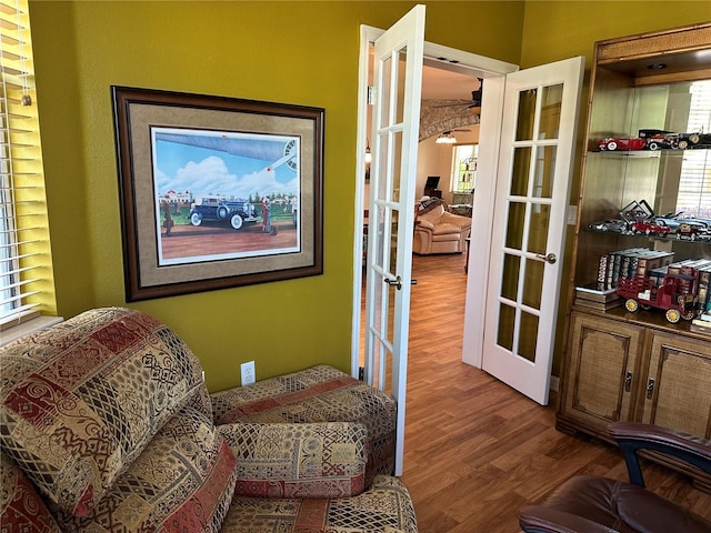 9053 SW 103rd Ave, Ocala, FL 34481 - sitting room featuring french doors, wood finished floors, a ceiling fan, and plenty of natural light
