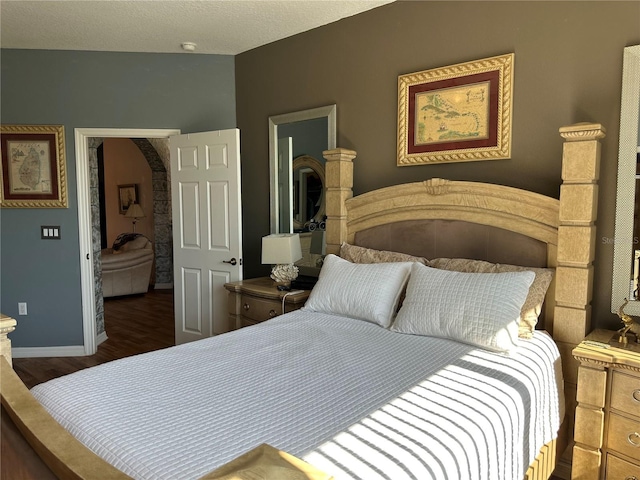 9053 SW 103rd Ave, Ocala, FL 34481 - bedroom with wood finished floors, arched walkways, and baseboards