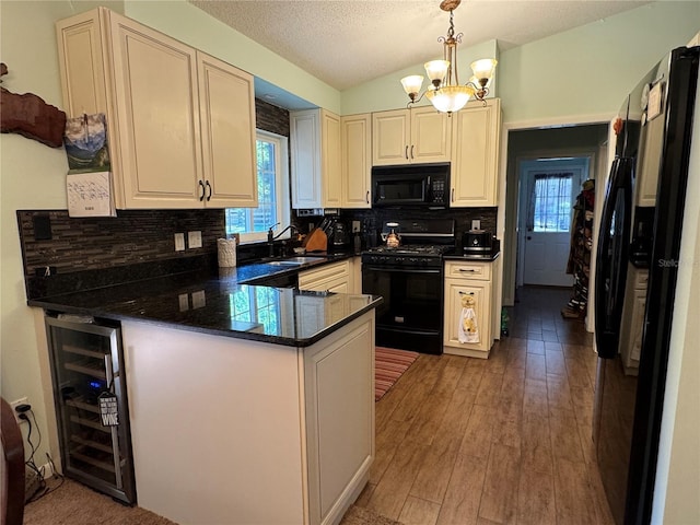 4540 W Sandy Hill St, Lecanto, FL 34461 - kitchen featuring black appliances, beverage cooler, a peninsula, dark countertops, and a chandelier