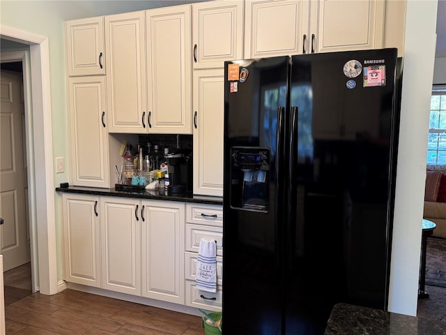 4540 W Sandy Hill St, Lecanto, FL 34461 - kitchen featuring black fridge with ice dispenser, wood finished floors, and white cabinetry