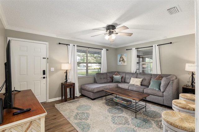 6830 NW 62nd Pl, Ocala, FL 34482 - living area featuring crown molding, a ceiling fan, wood finished floors, a textured ceiling, and visible vents