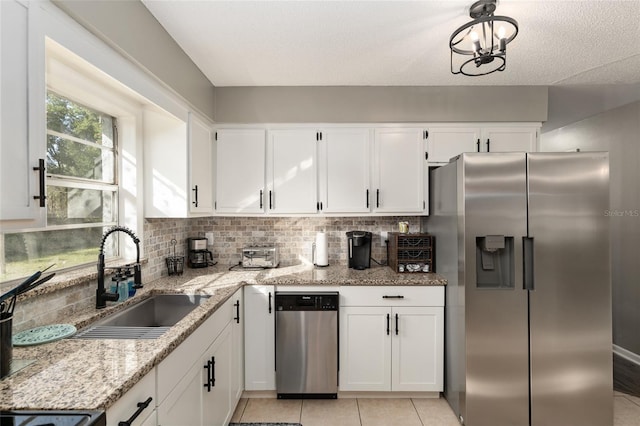 6830 NW 62nd Pl, Ocala, FL 34482 - kitchen with stainless steel fridge with ice dispenser, white cabinetry, decorative backsplash, and a sink