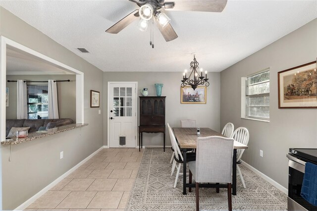 6830 NW 62nd Pl, Ocala, FL 34482 - dining area with light tile patterned flooring, a textured ceiling, baseboards, ceiling fan with notable chandelier, and visible vents