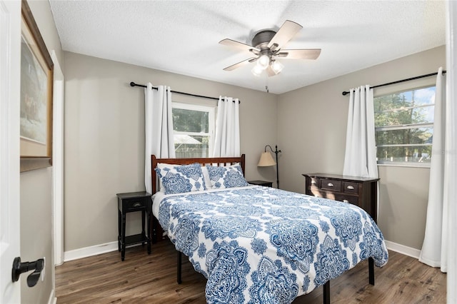 6830 NW 62nd Pl, Ocala, FL 34482 - bedroom with multiple windows, wood finished floors, baseboards, and a textured ceiling