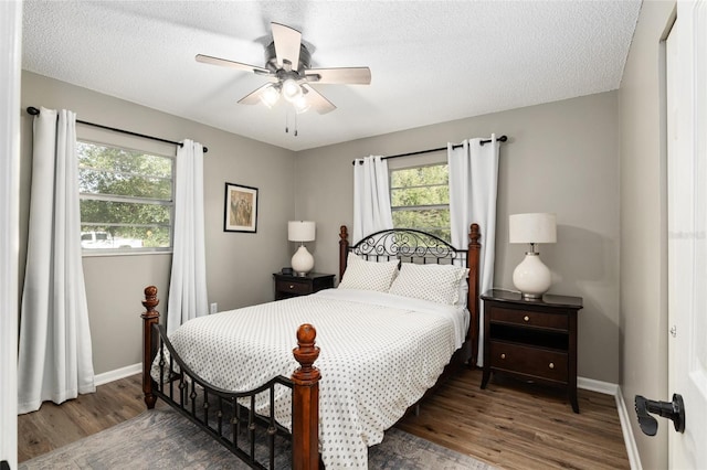 6830 NW 62nd Pl, Ocala, FL 34482 - bedroom featuring baseboards, multiple windows, a textured ceiling, and wood finished floors