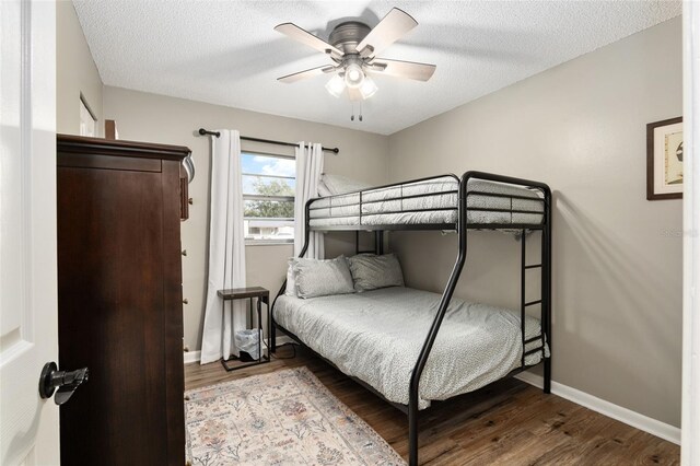 6830 NW 62nd Pl, Ocala, FL 34482 - bedroom featuring baseboards, wood finished floors, ceiling fan, and a textured ceiling