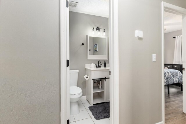 6830 NW 62nd Pl, Ocala, FL 34482 - half bath with toilet, a sink, tile patterned flooring, ensuite bathroom, and visible vents