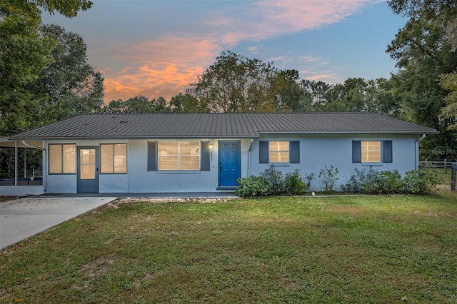6830 NW 62nd Pl, Ocala, FL 34482 - ranch-style home with a front yard, stucco siding, fence, and metal roof
