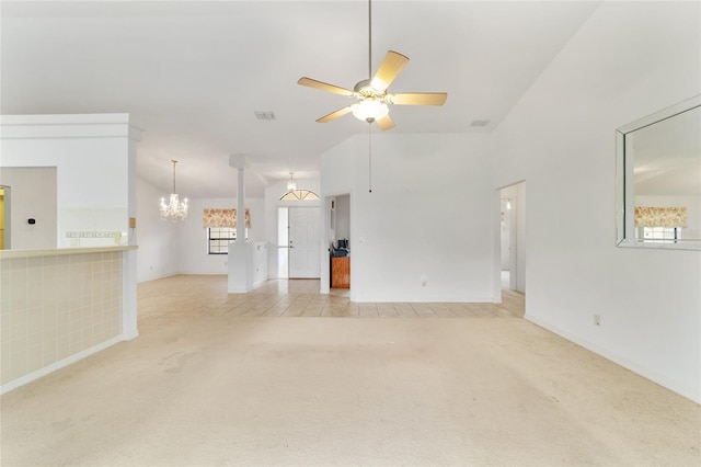 unfurnished living room featuring light colored carpet, a chandelier, ceiling fan, baseboards, and high vaulted ceiling