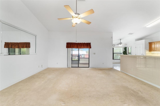 unfurnished living room with a ceiling fan and carpet floors