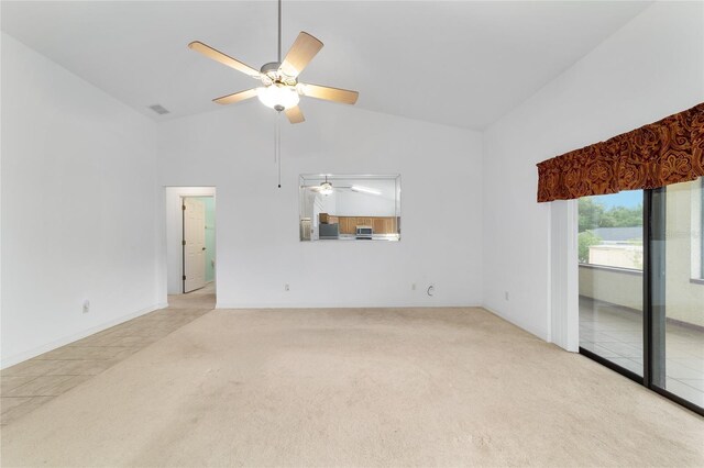 empty room with light colored carpet, ceiling fan, high vaulted ceiling, and baseboards