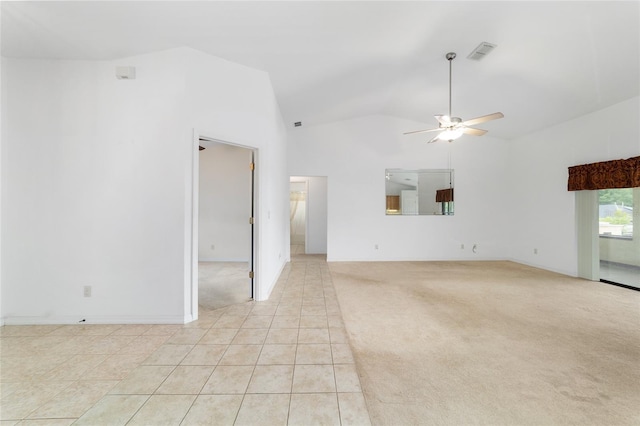 unfurnished living room with ceiling fan, vaulted ceiling, light colored carpet, and light tile patterned flooring