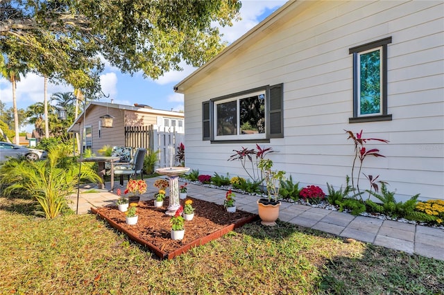 view of home's exterior with fence and a patio area