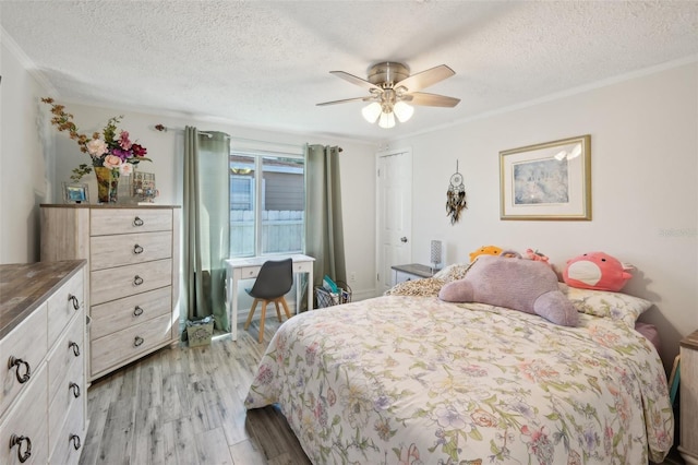 bedroom with a ceiling fan, ornamental molding, light wood-style floors, and a textured ceiling