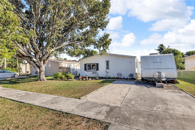 view of front of home with fence and a front yard