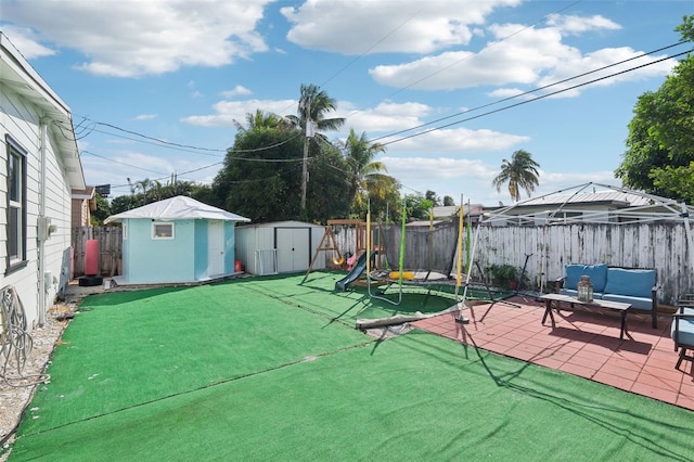 view of patio with a fenced backyard, a shed, and an outbuilding