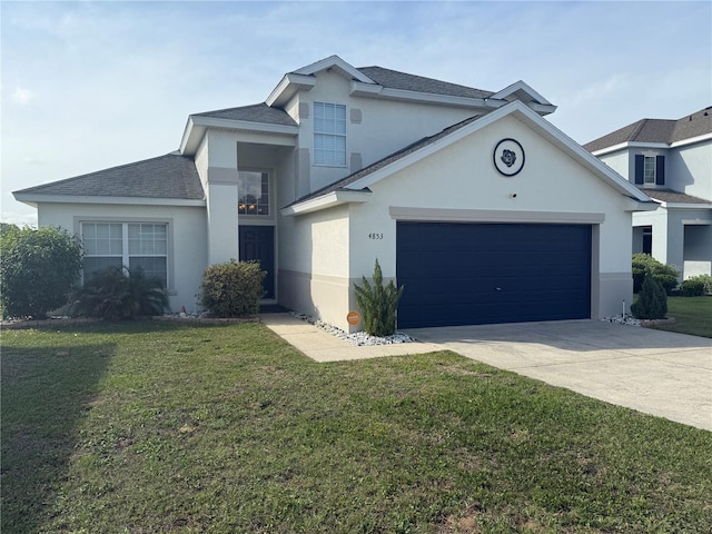 view of front of property featuring stucco siding, driveway, a front yard, an attached garage, and roof with shingles