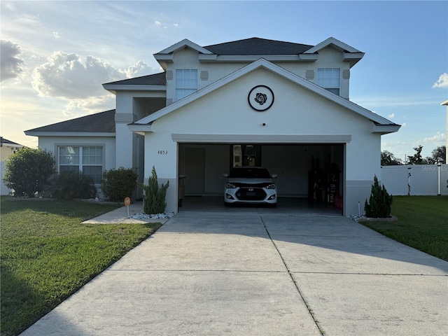 view of front of house featuring concrete driveway, stucco siding, and a shingled roof