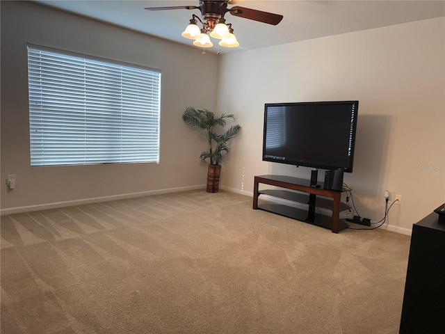 unfurnished living room with carpet flooring, ceiling fan, and baseboards