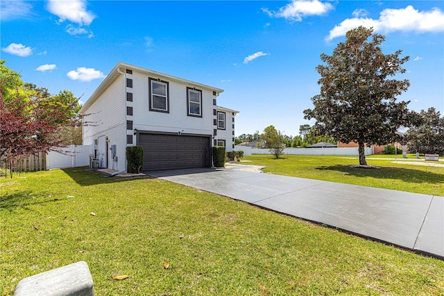 view of side of home featuring driveway, a garage, fence, and a yard
