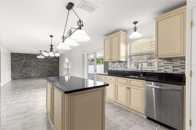 kitchen featuring stainless steel dishwasher, visible vents, cream cabinets, and a sink