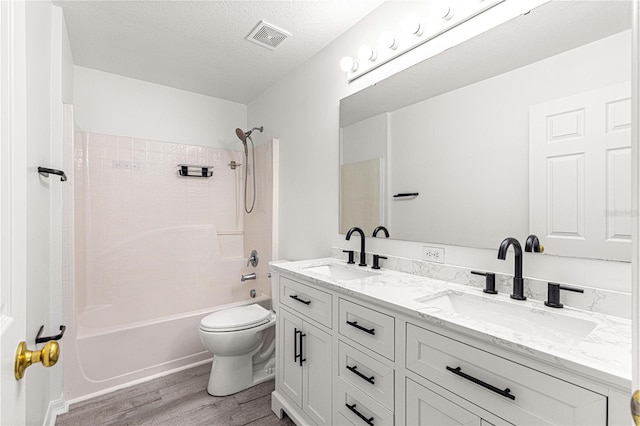 full bath with visible vents, a sink, toilet, and wood finished floors