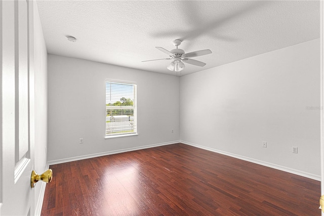 spare room with a textured ceiling, baseboards, wood finished floors, and a ceiling fan